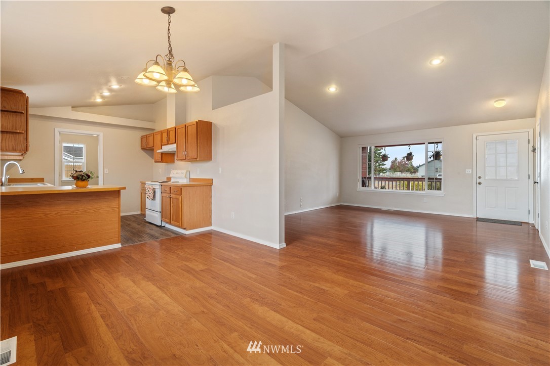 18126 Leitner Road Southwest Rochester, WA 98579 - Photo 13 of 29 a view of a kitchen with a stove cabinets and wooden floor