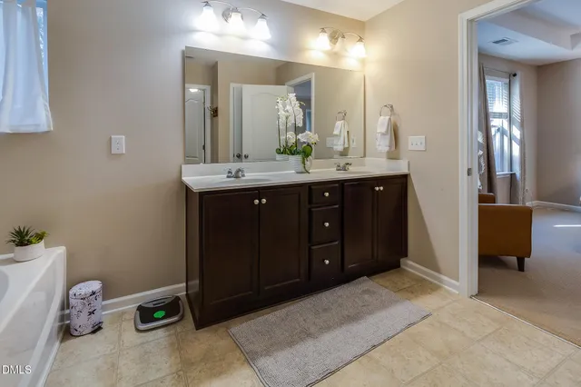 a spacious bathroom with a double vanity sink and a mirror