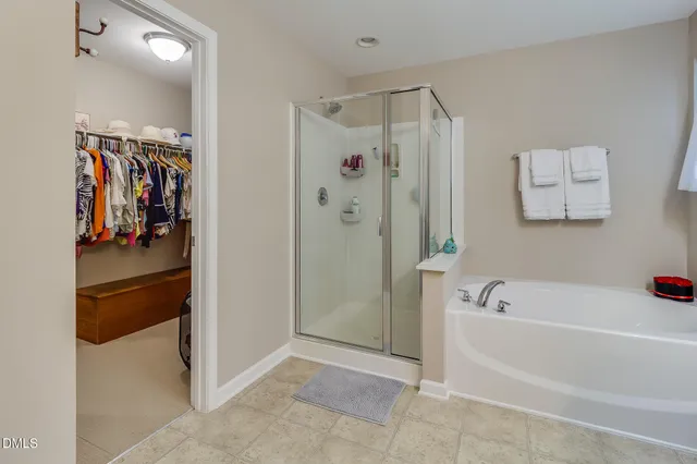 a bathroom with a shower and a tub