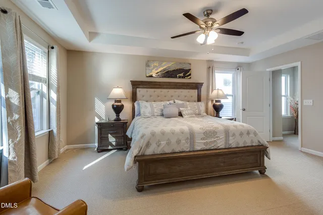 a bed room with a bed and a ceiling fan