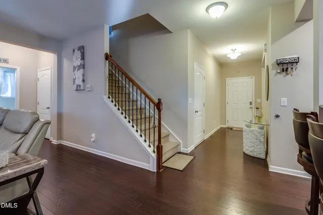 a view of a hallway with wooden floor and staircase