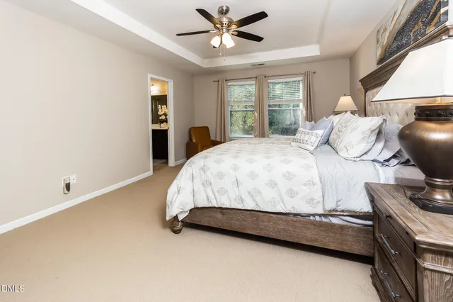 a bedroom with a bed and dresser with mirror