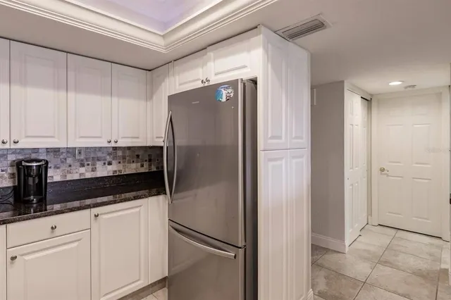 a kitchen with a refrigerator and cabinets