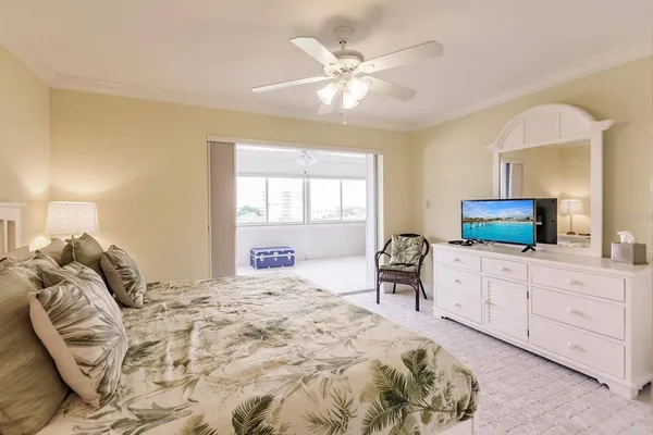 a bedroom with a bed and a television