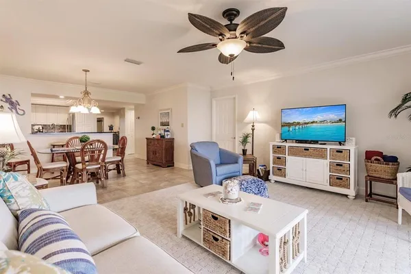 a living room with furniture and kitchen view