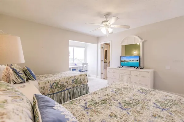 a bedroom with a large bed and a flat screen tv