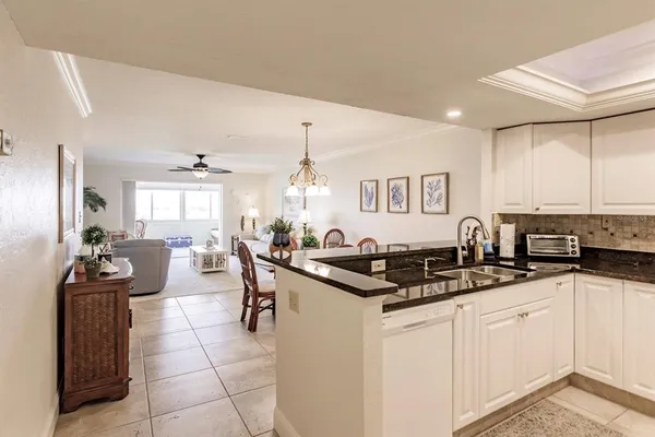 a kitchen with granite countertop a sink and cabinets