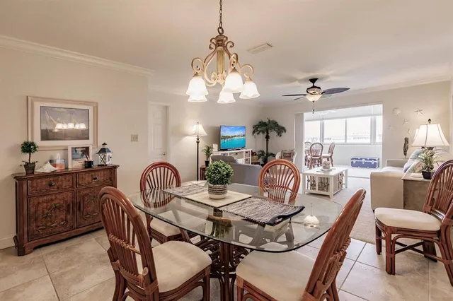 a view of a a dining room with furniture window and wooden floor