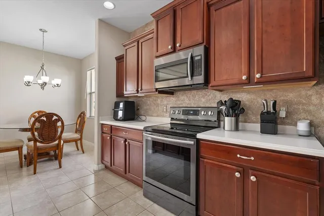 a kitchen with stainless steel appliances granite countertop a stove a sink and a microwave