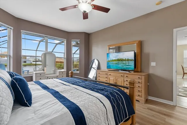 a bedroom with a bed and a large window