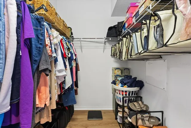 a view of walk in closet with clothes