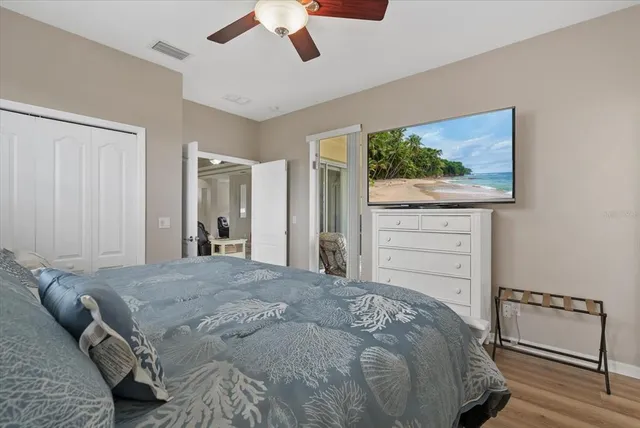 a bedroom with a bed and a painting on the wall