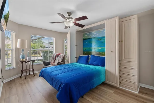 a bed room with a bed and a chair