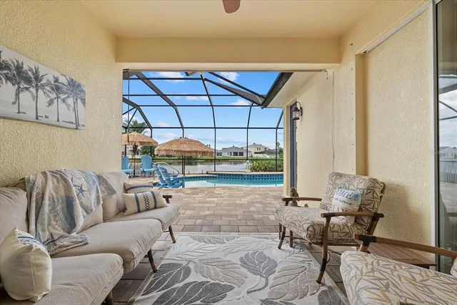 a living room with furniture and a floor to ceiling window