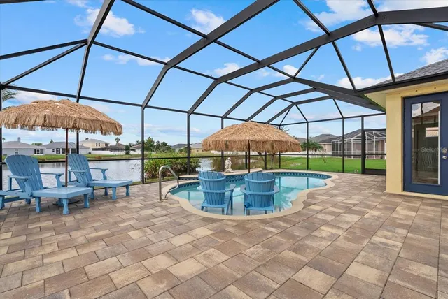 a view of a backyard with a patio and fire pit