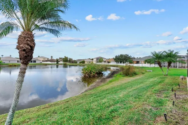 an aerial view of a house with a lake view