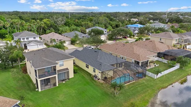 an aerial view of a house with a lake view