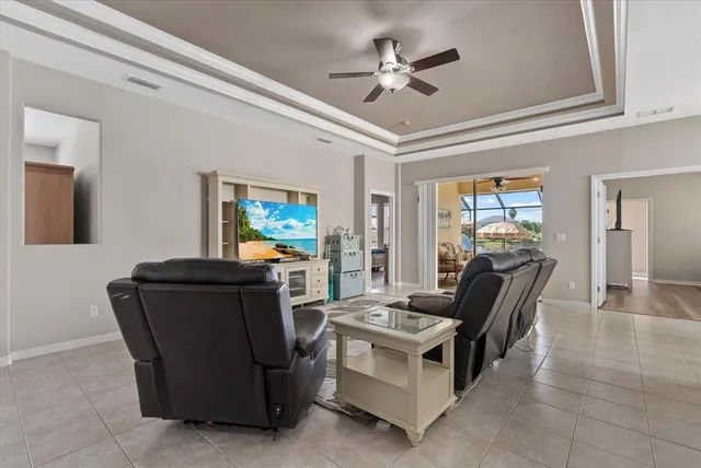 a living room with furniture and a chandelier