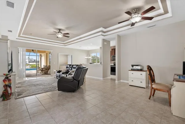 a living room with furniture and a chandelier