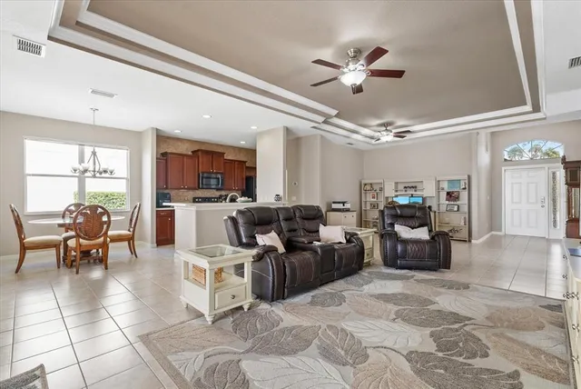 a living room with lots of furniture and kitchen view