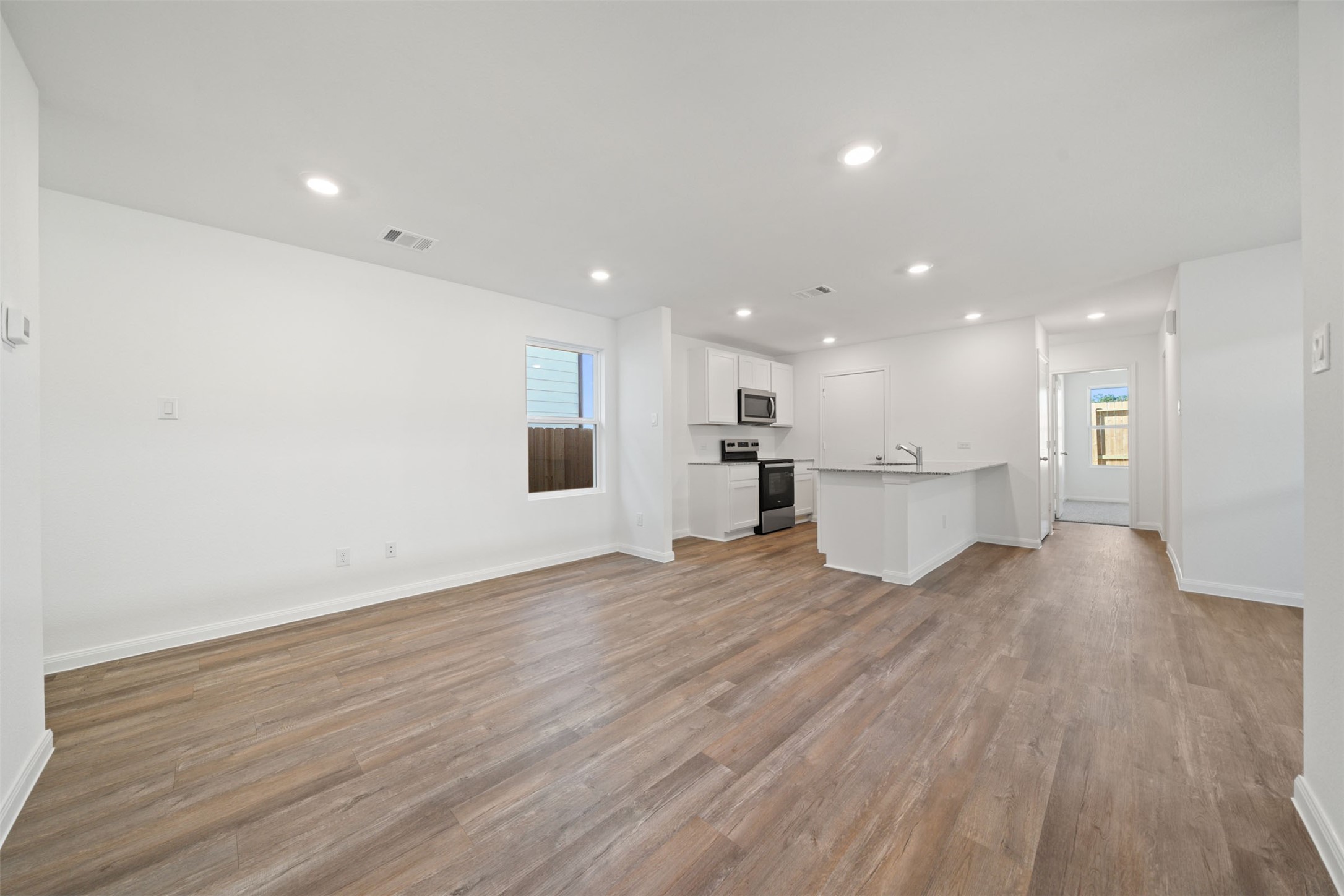 12327 Sword Point Court Willis, TX 77378 - Photo 11 of 30 a view of kitchen with wooden floor