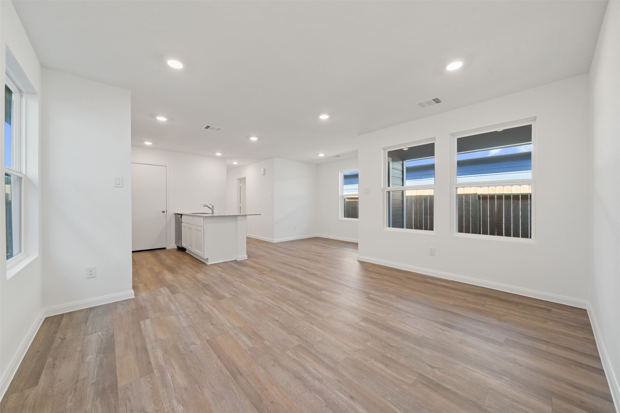 12327 Sword Point Court Willis, TX 77378 - Photo 12 of 30 a view of an empty room with wooden floor