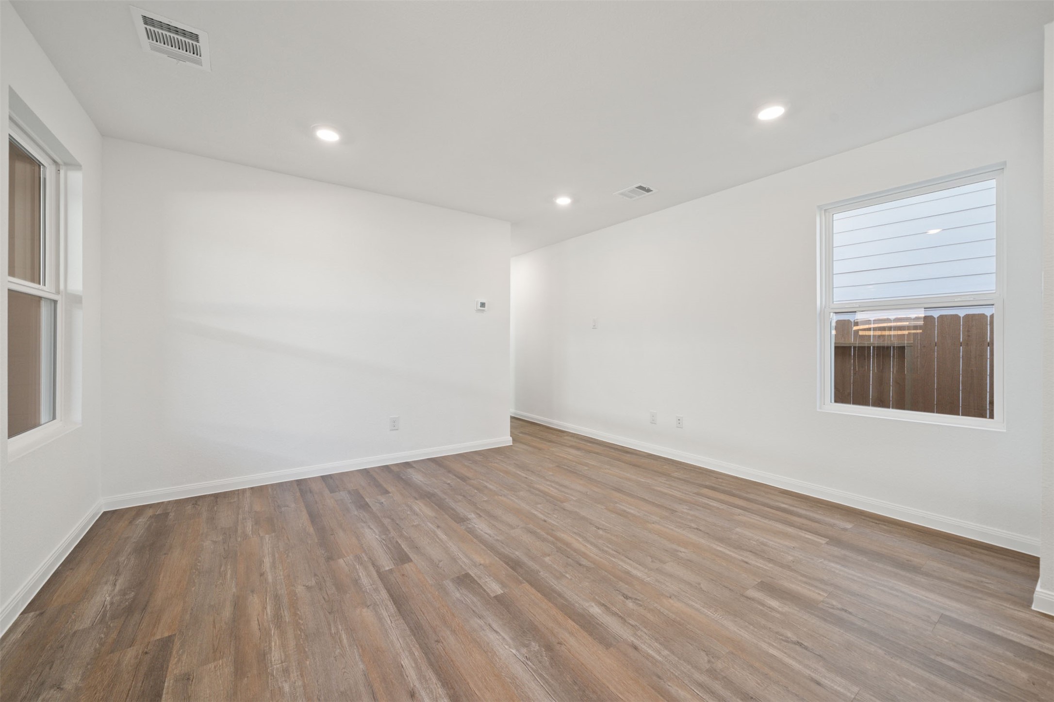 12327 Sword Point Court Willis, TX 77378 - Photo 16 of 30 a view of an empty room with wooden floor and a window