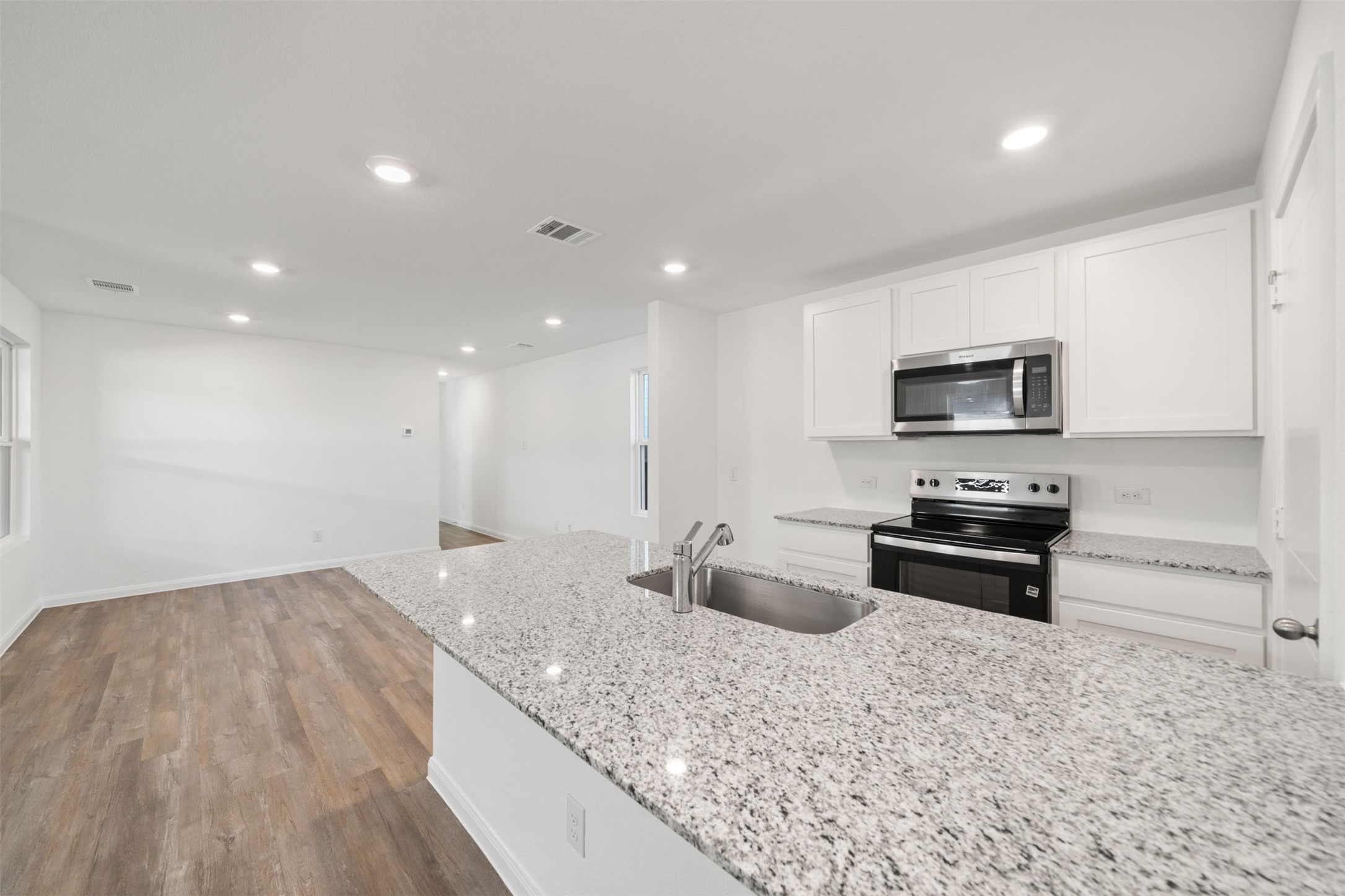 12327 Sword Point Court Willis, TX 77378 - Photo 19 of 30 a kitchen with stainless steel appliances granite countertop a sink stove and oven