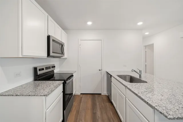 a kitchen with stainless steel appliances granite countertop a sink and a granite counter tops
