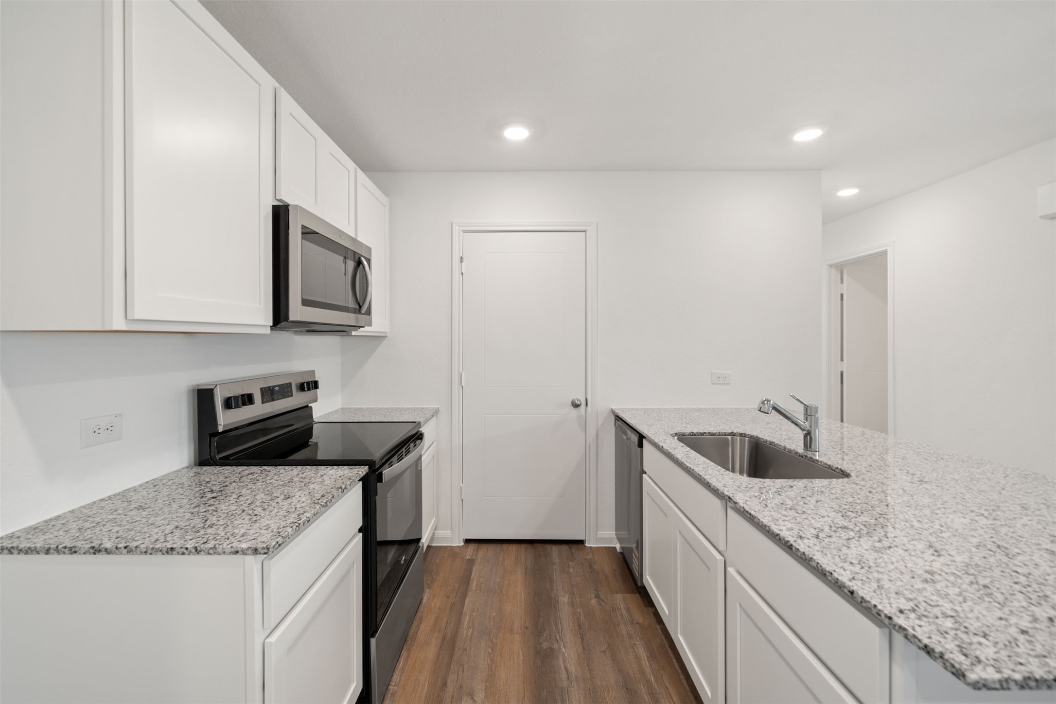 12327 Sword Point Court Willis, TX 77378 - Photo 20 of 30 a kitchen with stainless steel appliances granite countertop a sink and a granite counter tops