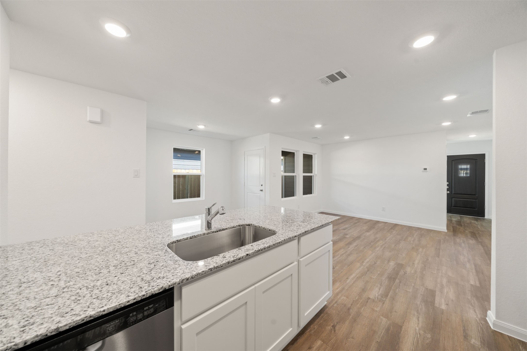 12327 Sword Point Court Willis, TX 77378 - Photo 21 of 30 a kitchen with granite countertop a sink and a granite counter tops