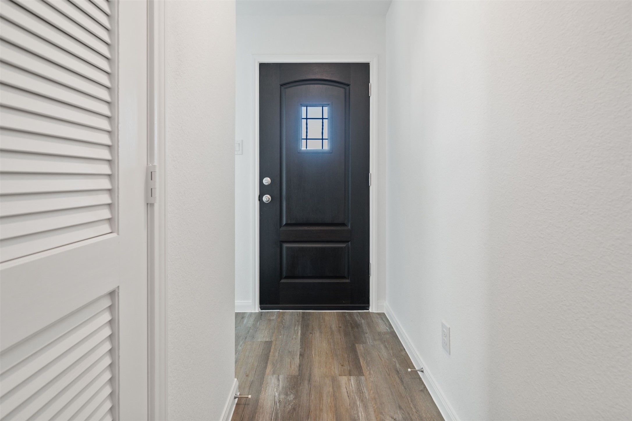 12327 Sword Point Court Willis, TX 77378 - Photo 5 of 30 a view of a hallway with wooden floor