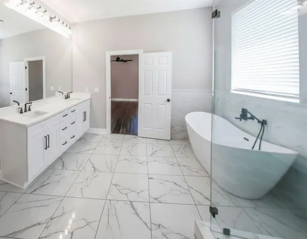 a spacious bathroom with a bathtub sink and toilet