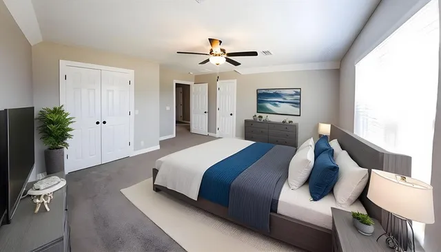 a spacious bedroom with a bed and a chandelier