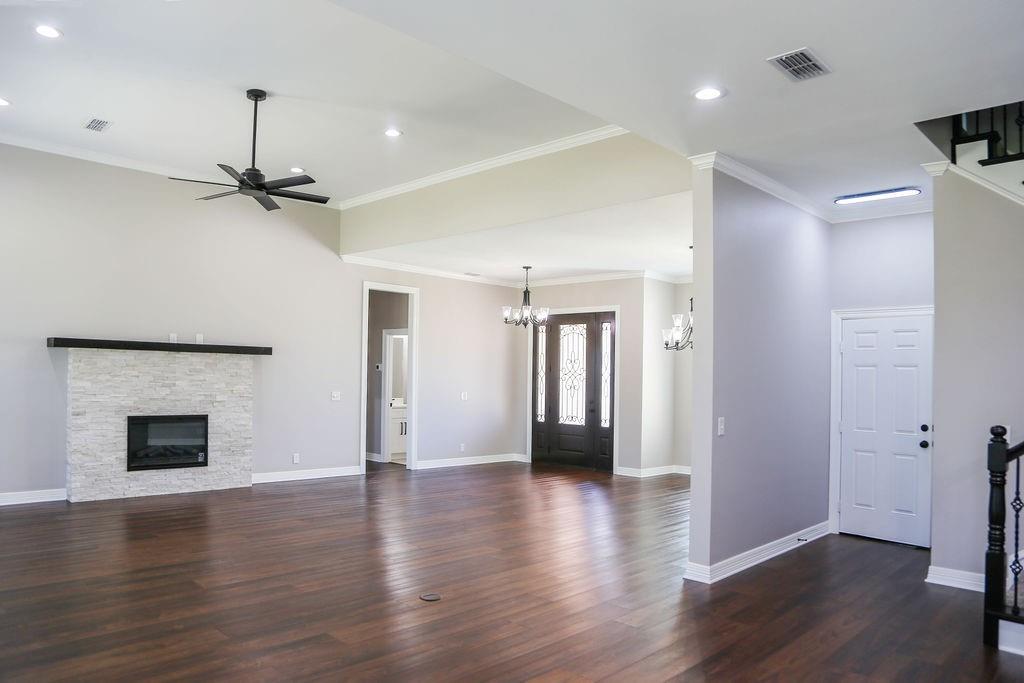 990 Baylor’s Way Reno, TX 75462 - Photo 4 of 22 a view of empty room with wooden floor and fireplace
