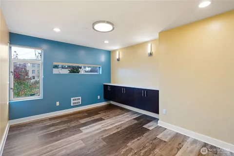 a view of empty room with wooden floor