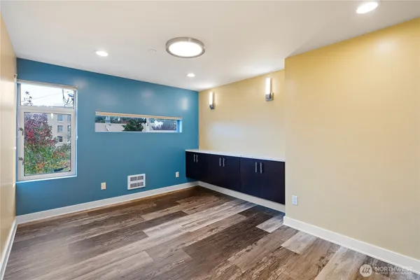 a view of empty room with wooden floor