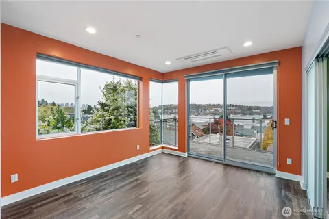 an empty room with wooden floor and a window