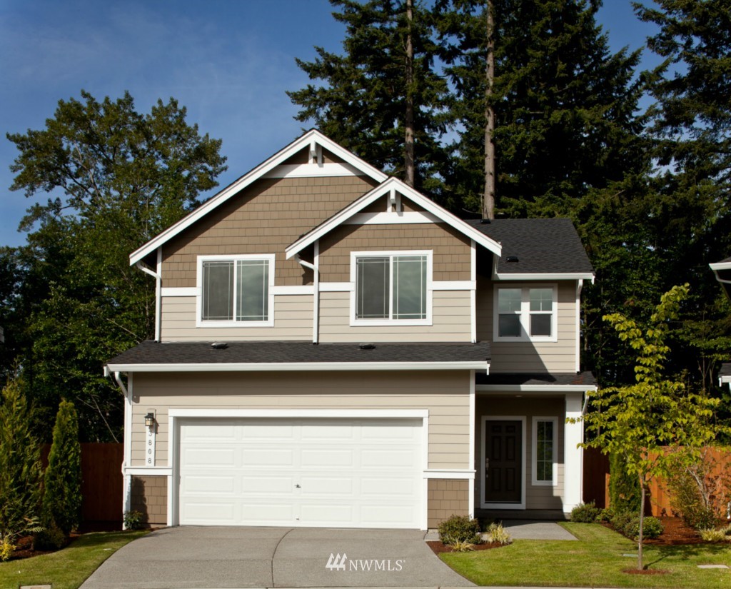 3701 196th Place Southeast, Unit 123 Bothell, WA 98012 - Photo 1 of 12 a front view of a house with a garden