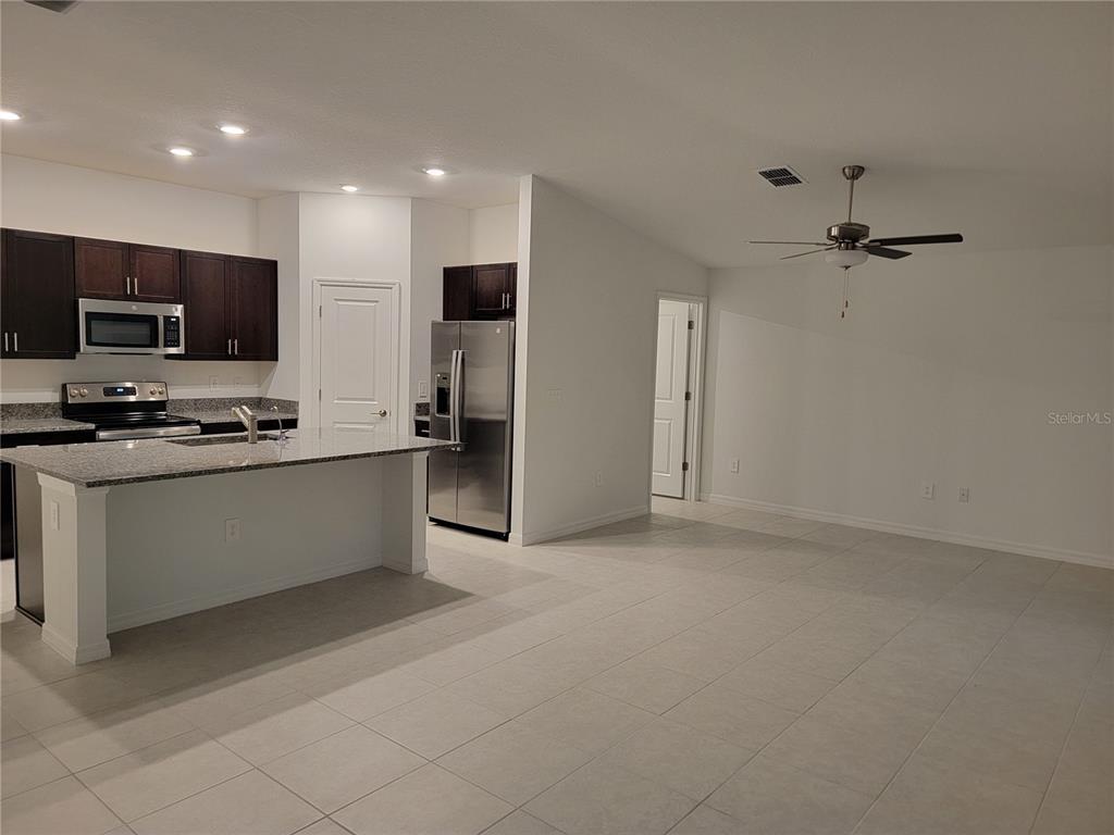 1844 Red Loop Lakeland, FL 33801 - Photo 12 of 24 a view of kitchen with stainless steel appliances refrigerator stove microwave and cabinets