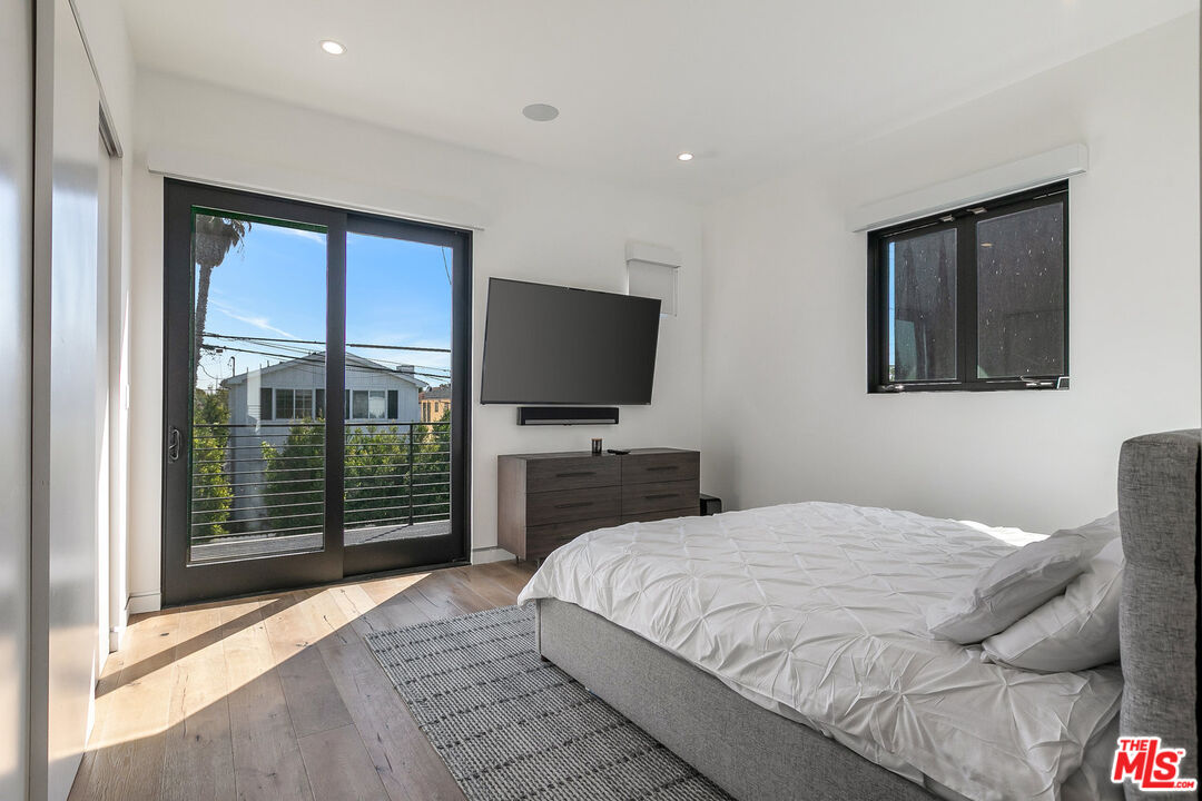 1060 Palms Boulevard Venice, CA 90291 - Photo 24 of 29 a bedroom with a large bed and a flat tv screen