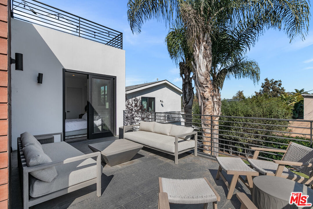 1060 Palms Boulevard Venice, CA 90291 - Photo 26 of 29 a view of a patio with couches and a fire pit next to a yard