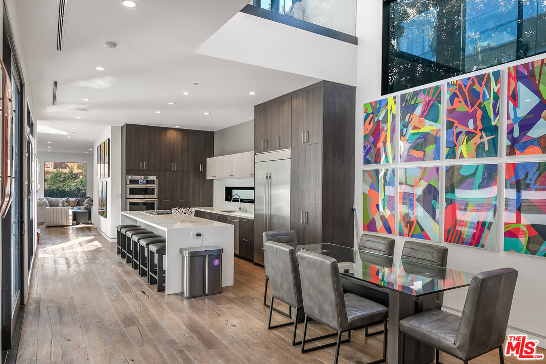 1060 Palms Boulevard Venice, CA 90291 - Photo 8 of 29 a kitchen with stainless steel appliances a dining table chairs and cabinets