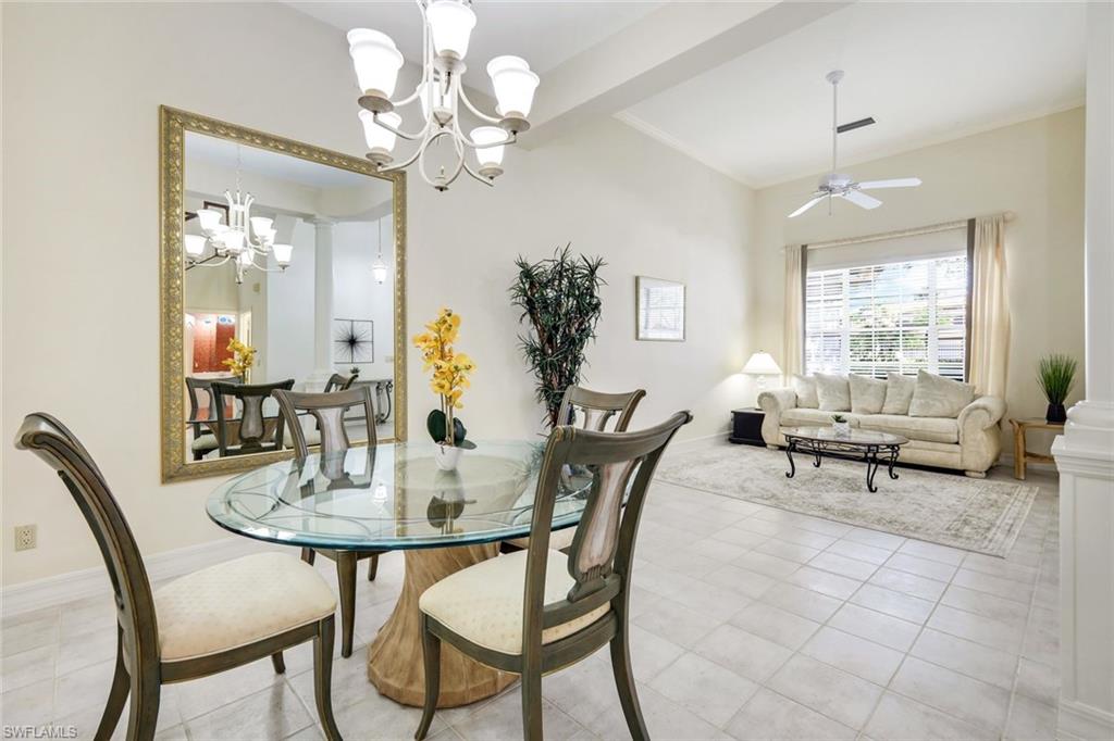 2451 Game Hawk Court, Unit 2502 Naples, FL 34105 - Photo 11 of 30 a view of a dining room with furniture and window