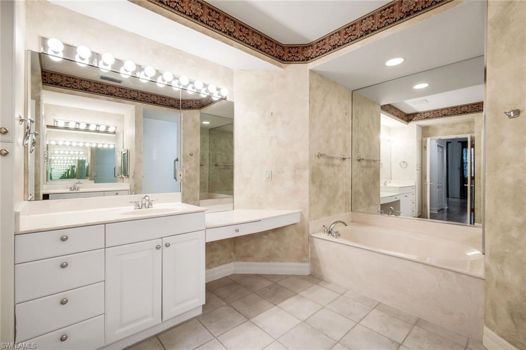 2451 Game Hawk Court, Unit 2502 Naples, FL 34105 - Photo 12 of 30 Dual sinks, soaking tub, and large walk in shower