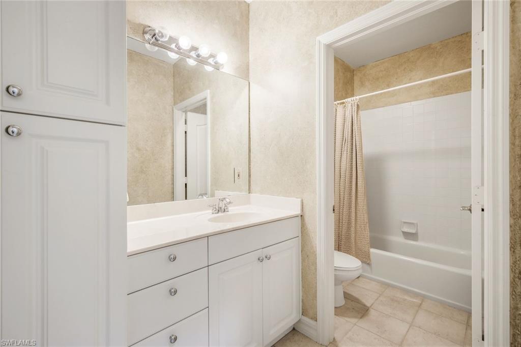 2451 Game Hawk Court, Unit 2502 Naples, FL 34105 - Photo 15 of 30 a bathroom with a sink a toilet and shower