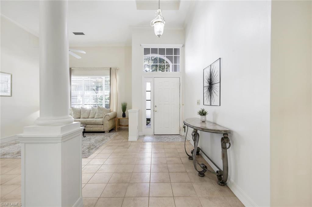 2451 Game Hawk Court, Unit 2502 Naples, FL 34105 - Photo 2 of 30 a spacious bathroom with a toilet a sink and a mirror
