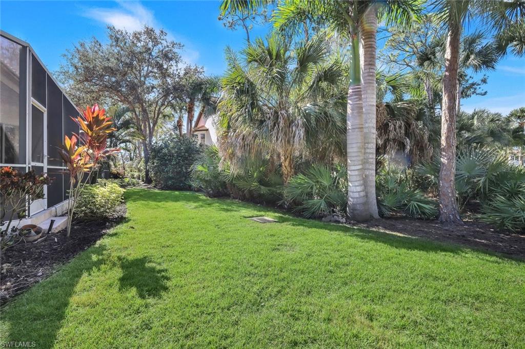 2451 Game Hawk Court, Unit 2502 Naples, FL 34105 - Photo 22 of 30 a view of a backyard with palm trees