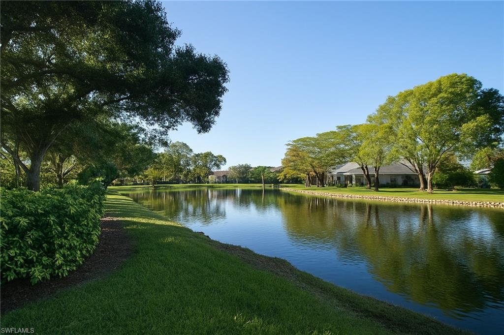 2451 Game Hawk Court, Unit 2502 Naples, FL 34105 - Photo 23 of 30 a view of a lake with a yard