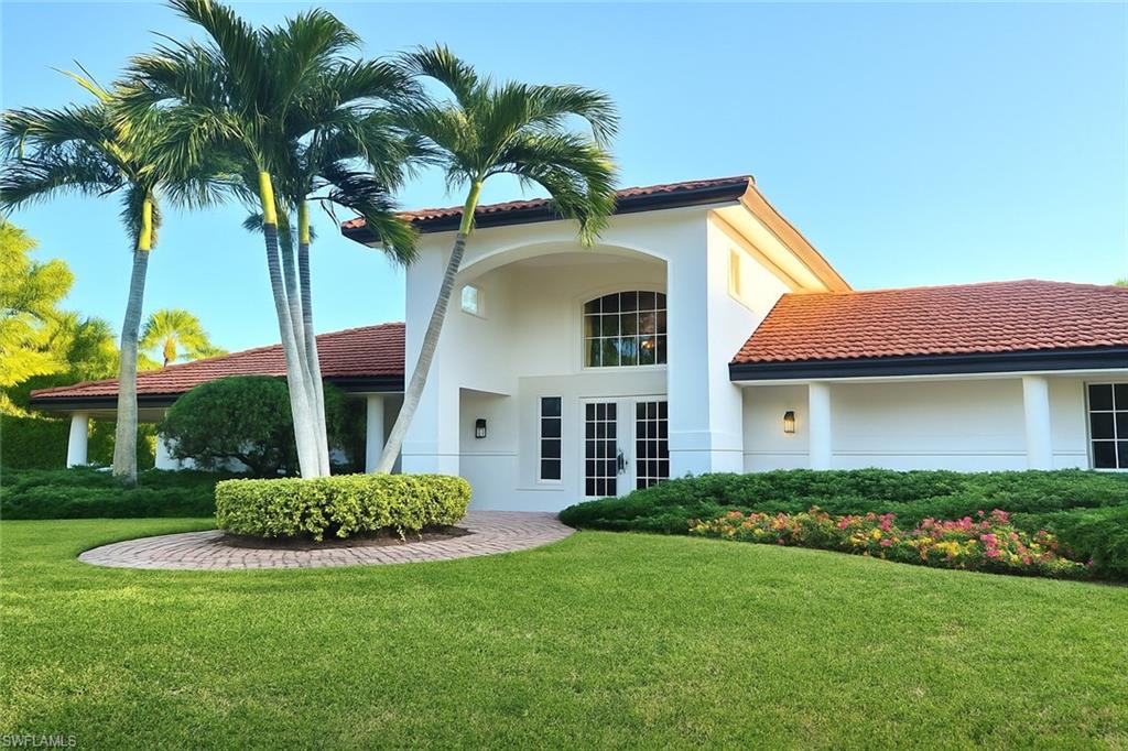 2451 Game Hawk Court, Unit 2502 Naples, FL 34105 - Photo 24 of 30 a front view of house with yard and green space